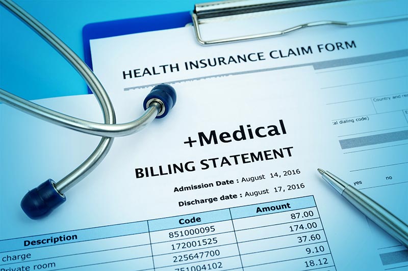 A stethoscope resting on healthcare documents, illustrating the discussion of wisdom tooth extraction cost with insurance and available dental payment options at River Ridge Oral & Maxillofacial Surgical Center.