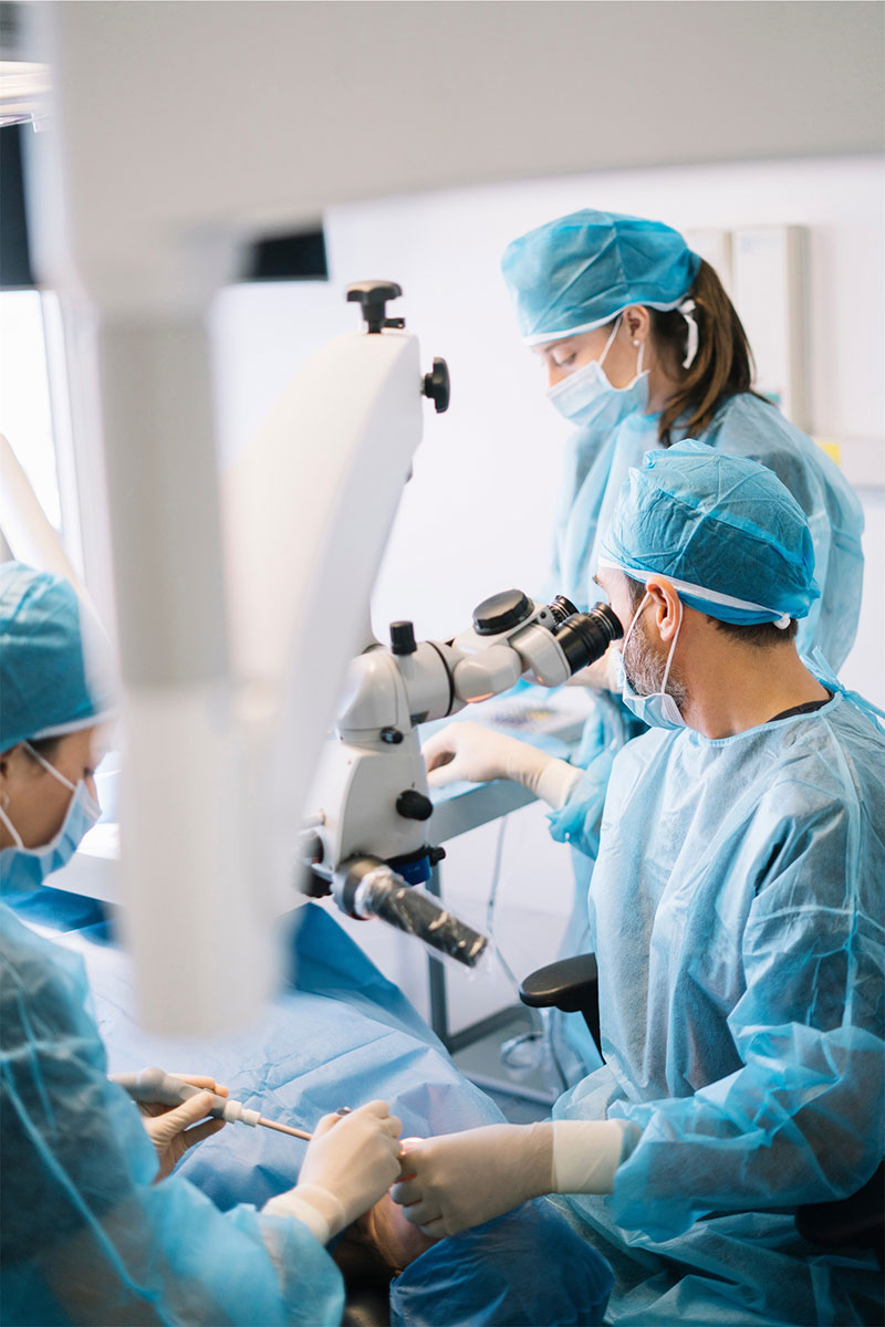 A highly skilled surgical team at River Ridge Oral & Maxillofacial Surgical Center utilizing advanced microscopic technology to perform a high-precision apicoectomy or complex root canal surgery in a sterile environment.