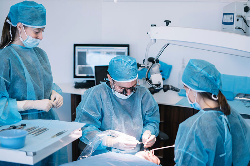 A highly skilled surgical team at River Ridge Oral & Maxillofacial Surgical Center performing a complex corrective jaw surgery or wisdom teeth removal with precision in a sterile, state-of-the-art operating room.