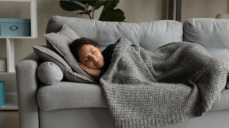 A patient resting comfortably at home during their oral surgery recovery, following a safe and successful sedation dentistry procedure or wisdom teeth removal at River Ridge Oral & Maxillofacial Surgical Center.