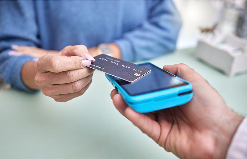 A patient at River Ridge Oral & Maxillofacial Surgical Center conveniently managing their oral surgery costs or finalizing a payment for dental implant services using modern, secure contactless payment options.